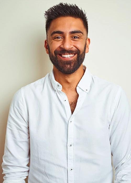 Smiling man in white button-up shirt