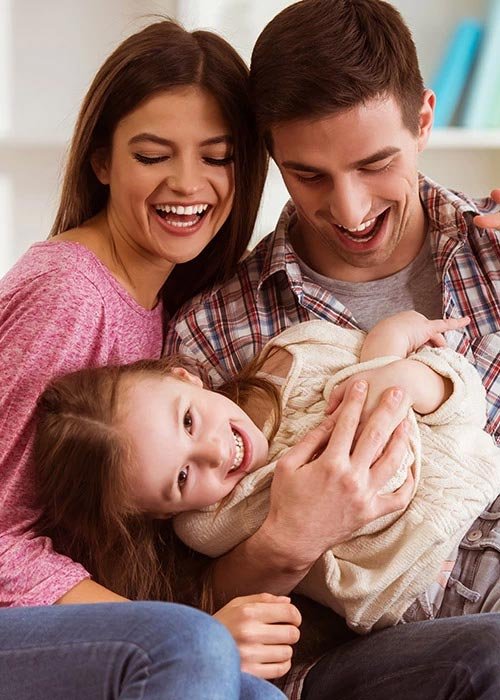 Smiling mother, father, and young girl